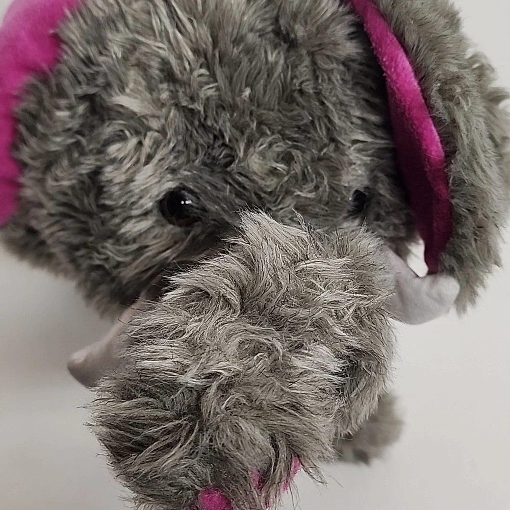 Plush Elephant Hat with Pink Ears, White Tusks, And Adorable Trunk.
